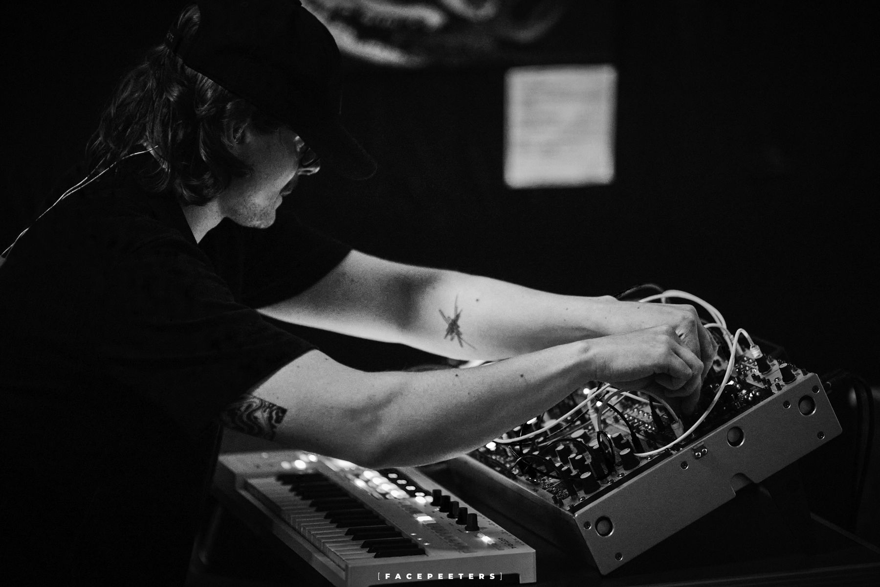 Hands patching cables on a modular synthesizer