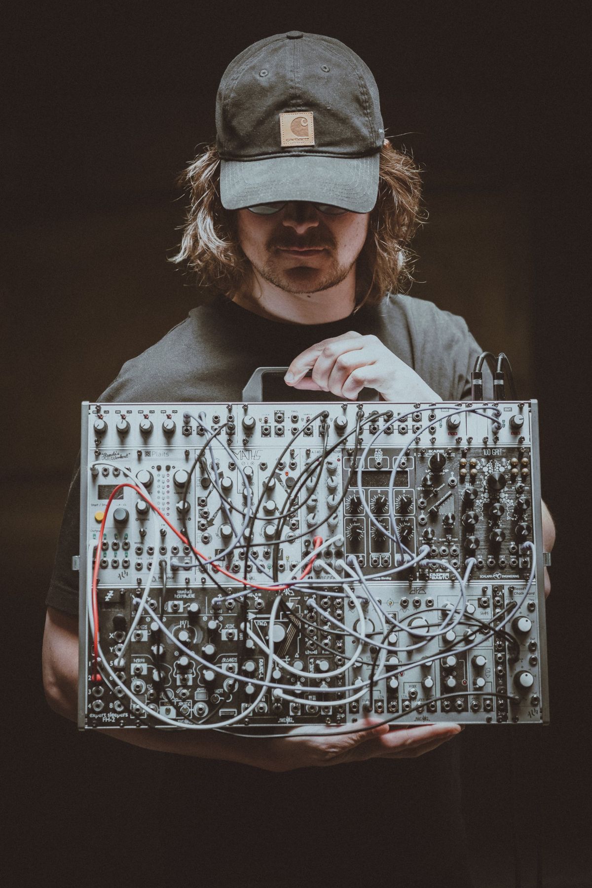 Løgømyx holding his modular synthesizer