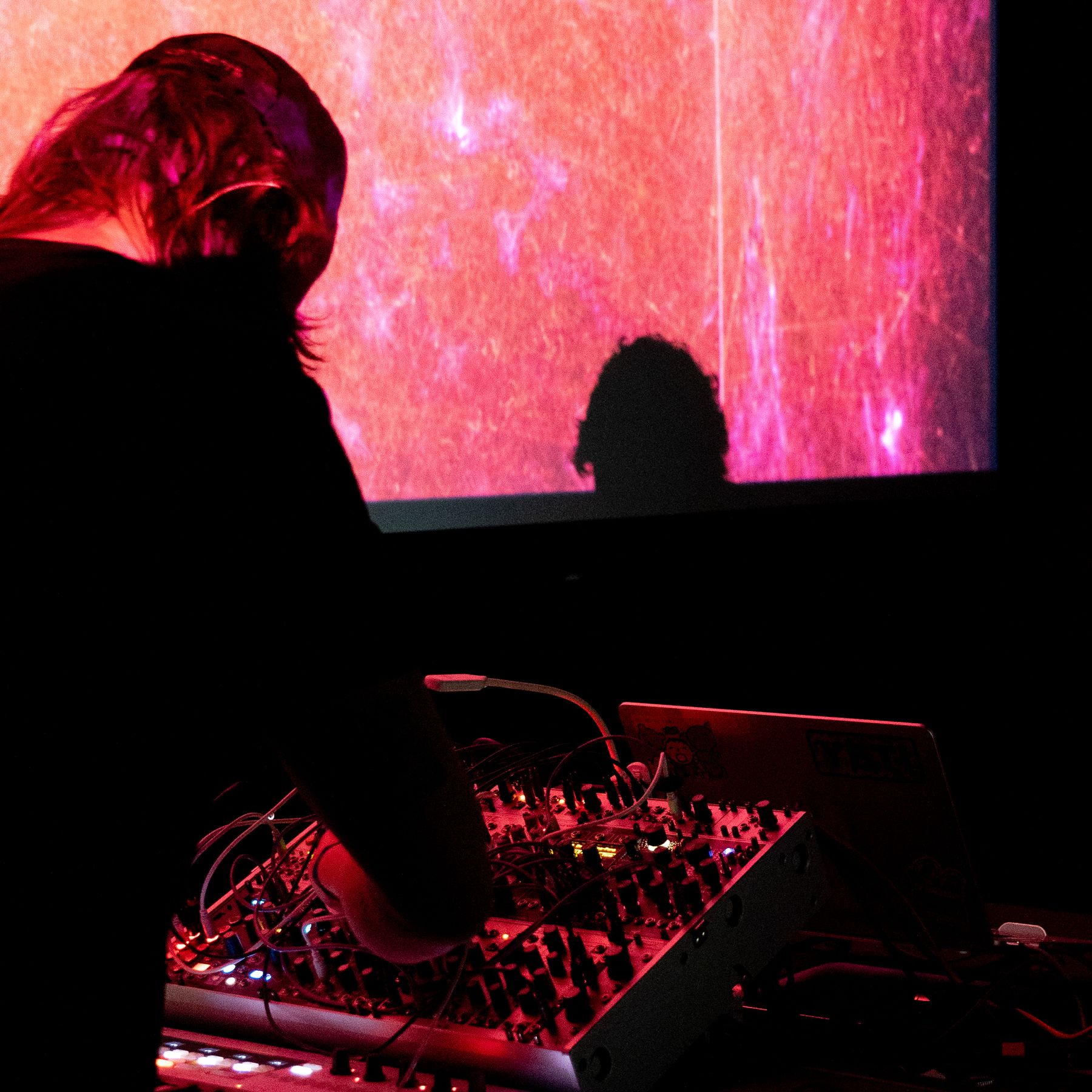 Silhouette at the modular rig against a red projected visual